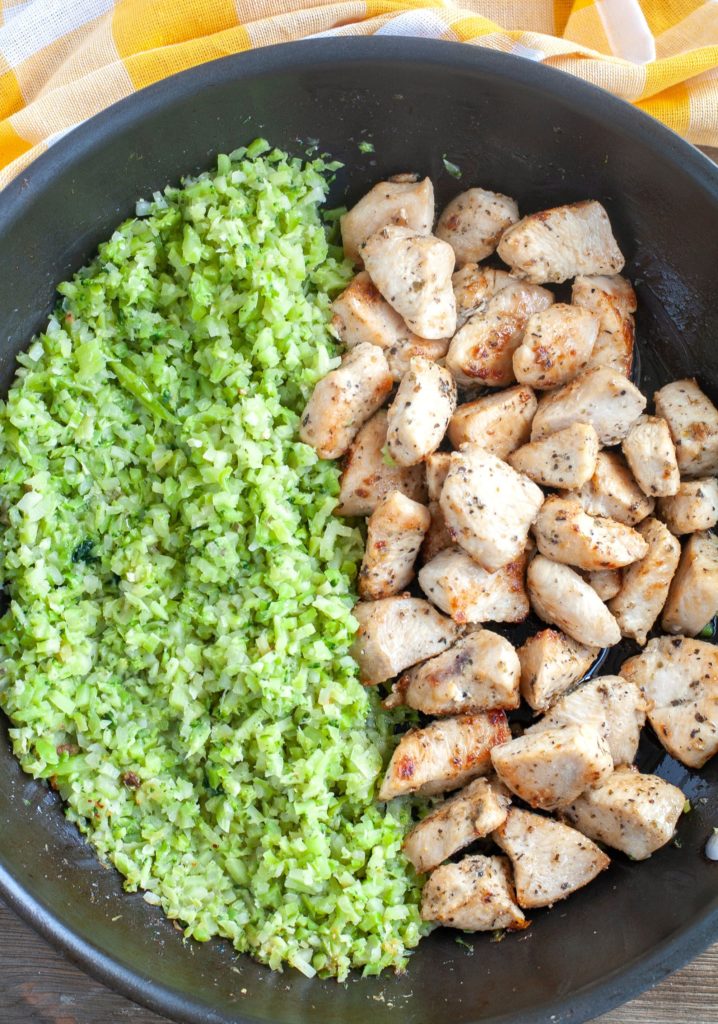 Garlic Butter Chicken with riced cauliflower and broccoli in a skillet