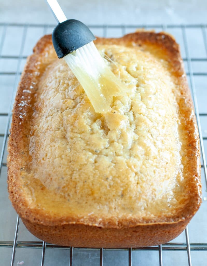 Glazed being brushed on cake