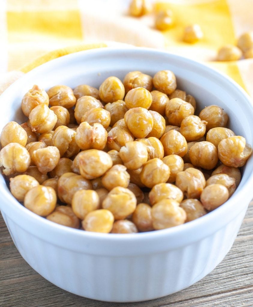 roasted chickpeas in a white bowl with yellow towel