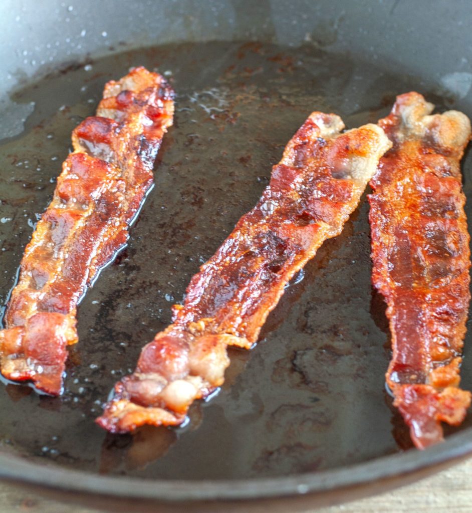 3 pieces of bacon in the skillet