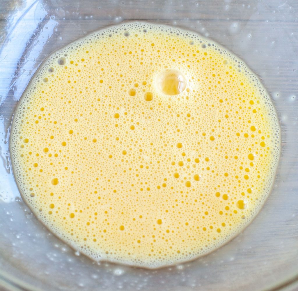 Eggs beaten in a glass bowl