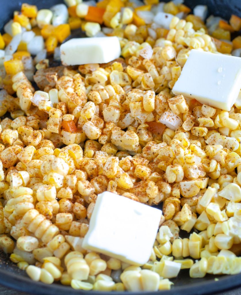 Corn with butter and Cajun seasoning in a skillet