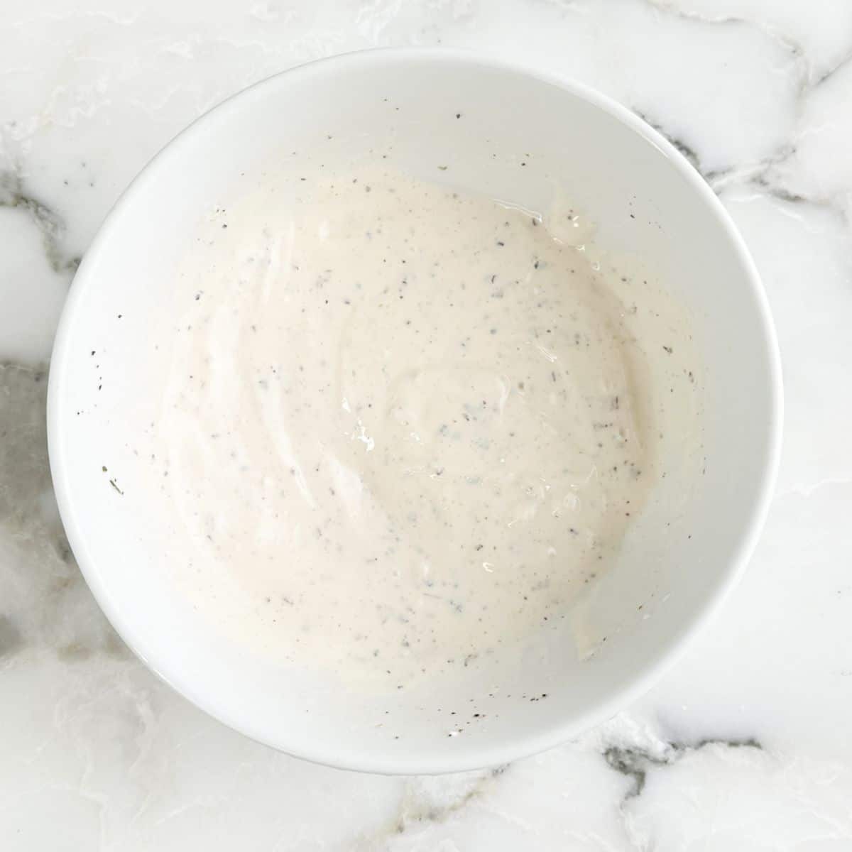 Bowl of creamy dressing. 