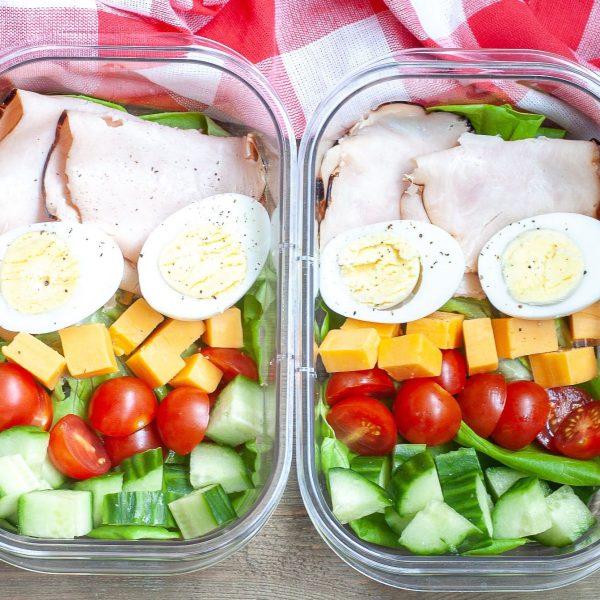 Container with hard boiled eggs, turkey and vegetables.