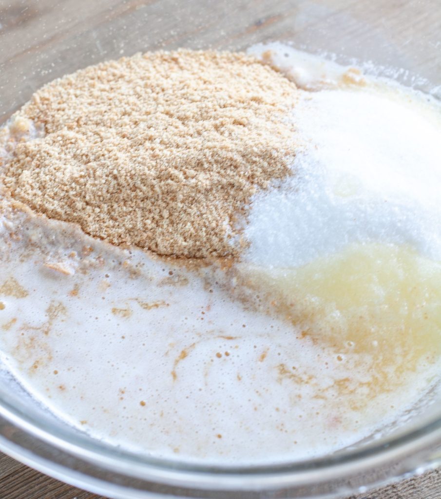 A bowl with crushed graham crackers, butter and sugar.