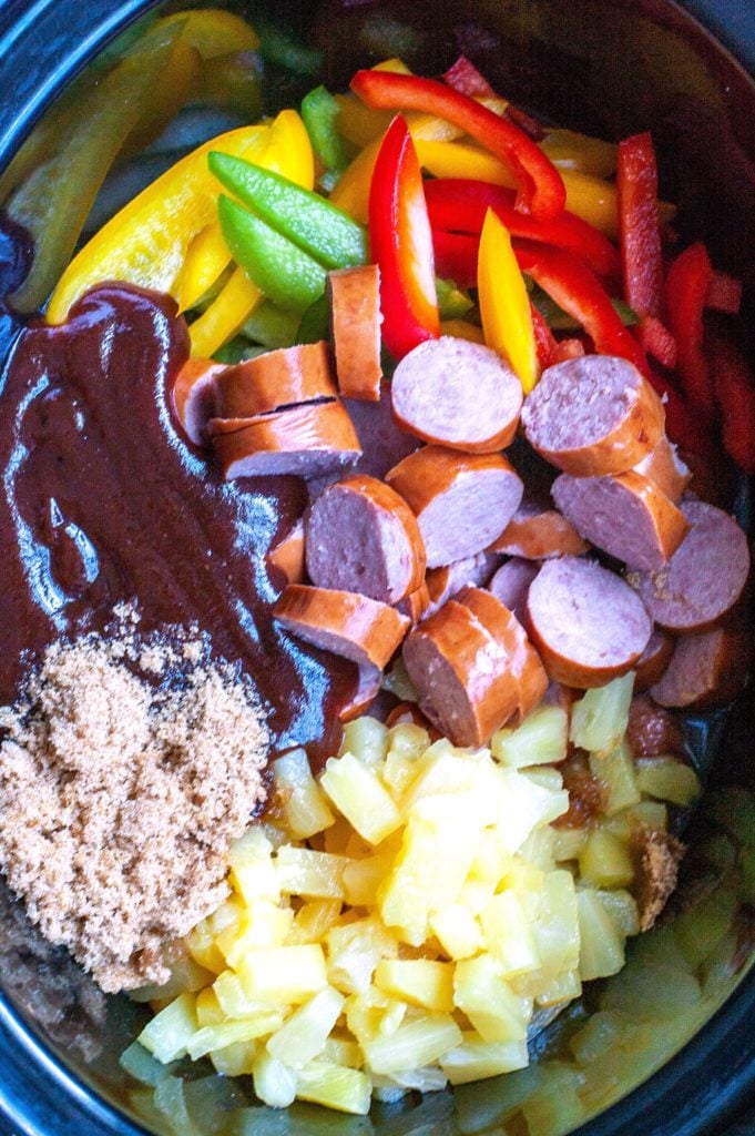 Peppers, kielbasa, pineapple, BBQ sauce and brown sugar in a crockpot