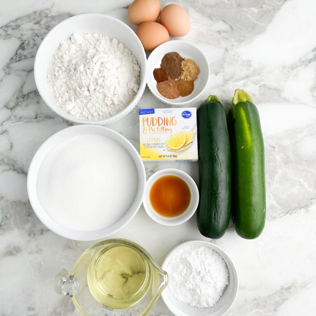 Zucchini, bowl of flour, sugar, eggs, lemon pudding mix. 