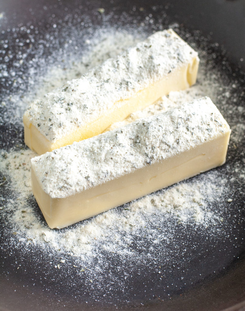 Two sticks of butter in a skillet with ranch seasoning. 