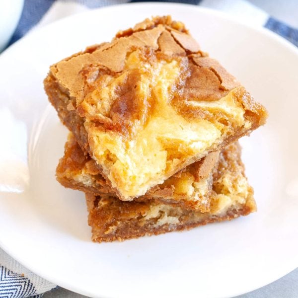 Three blondies stacked on plate.