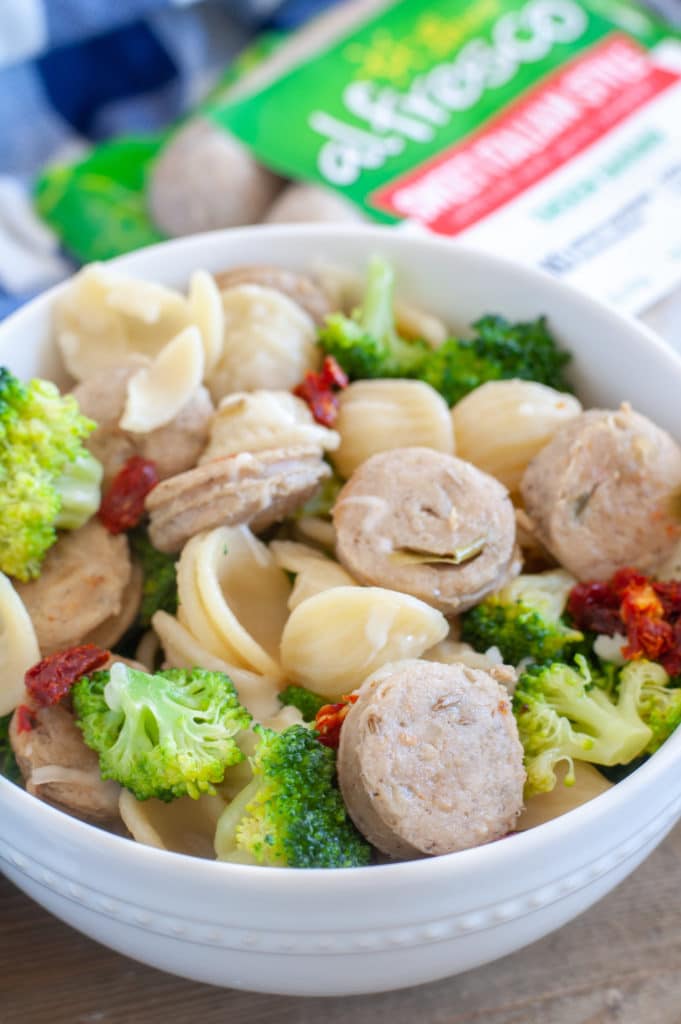 A bowl of pasta, broccoli and chicken sausage