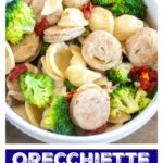 Bowl with sausage, pasta and broccoli.