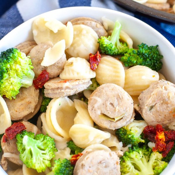 Bowl with sausage, pasta and broccoli.