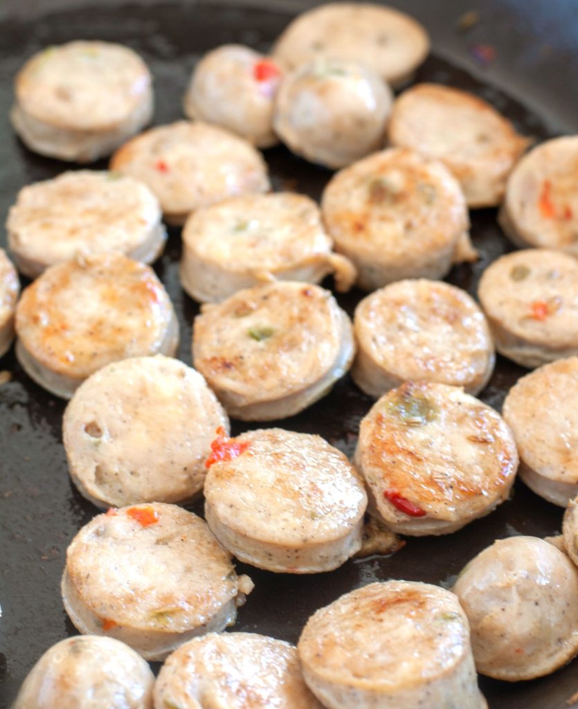 chicken sausage cooking in a skillet