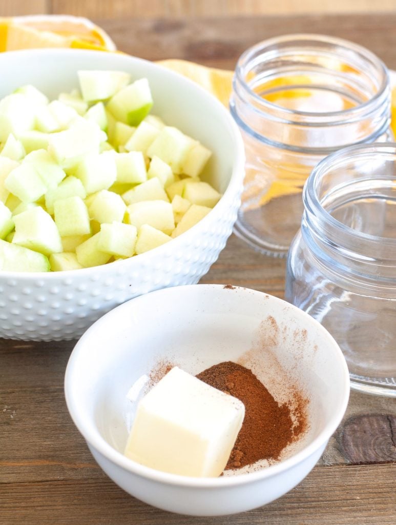 Diced apples, butter, spices and empty jars