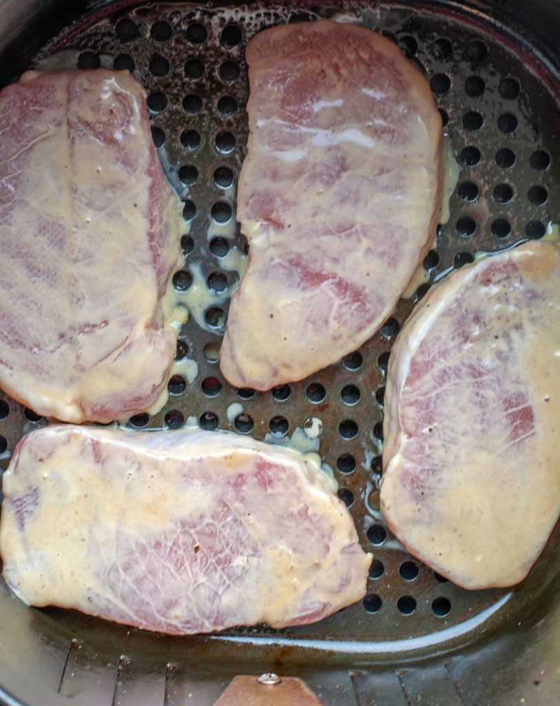 Four pork chops in Air Fryer basket