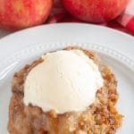 Plate with apple dump cake and scoop of ice cream