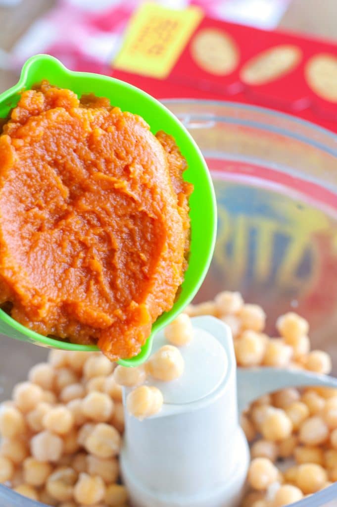 Cup of pumpkin puree going into chickpea hummus