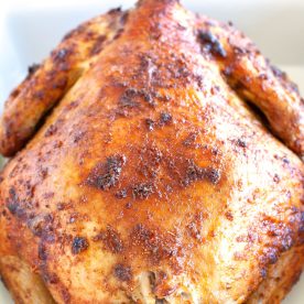 Whole chicken in baking dish.