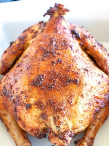 Whole chicken in baking dish.