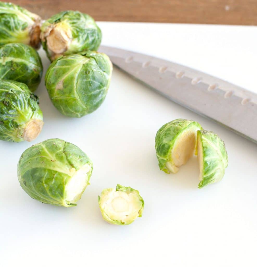 Brussels Sprouts on a cutting board with a knife