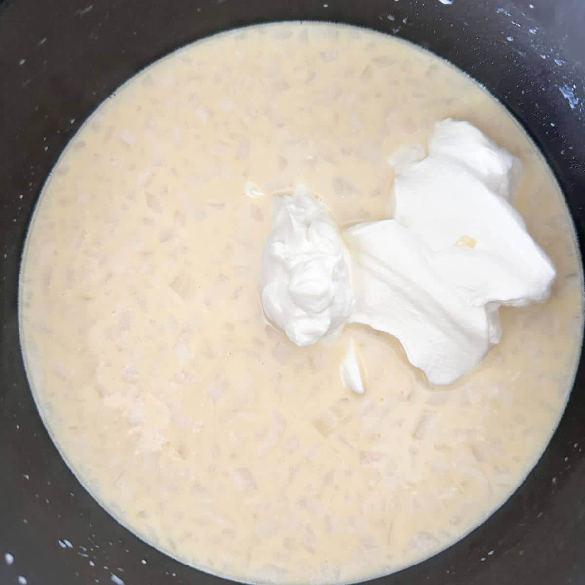 Saucepan with roux and sour cream.