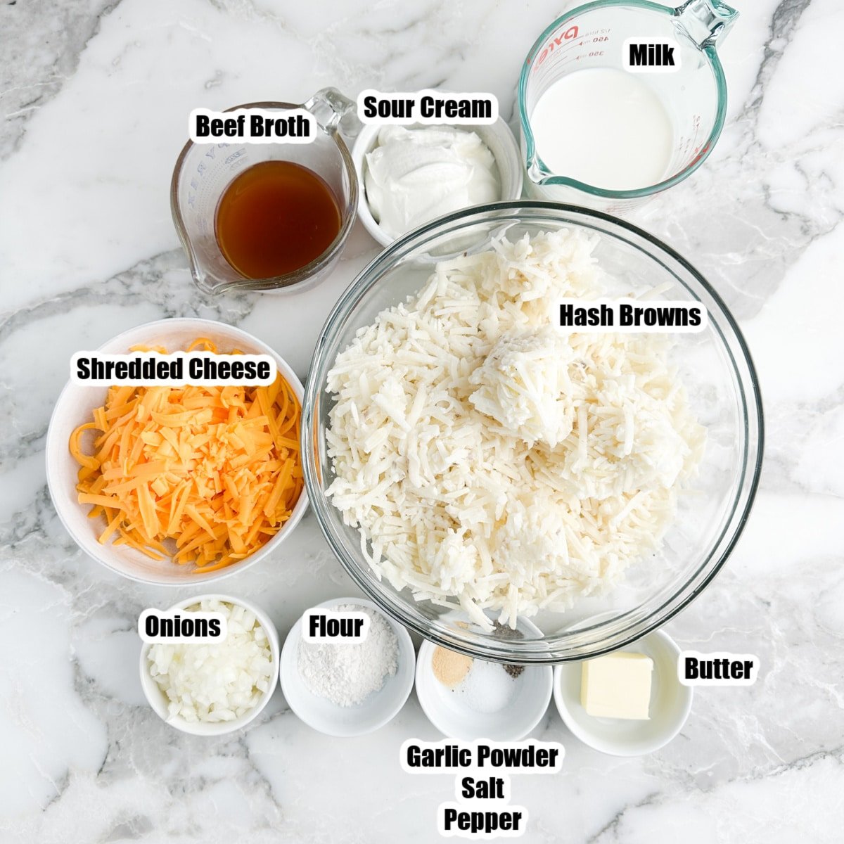Bowl of hash browns, shredded cheese, broth, milk, onions, and seasonings.
