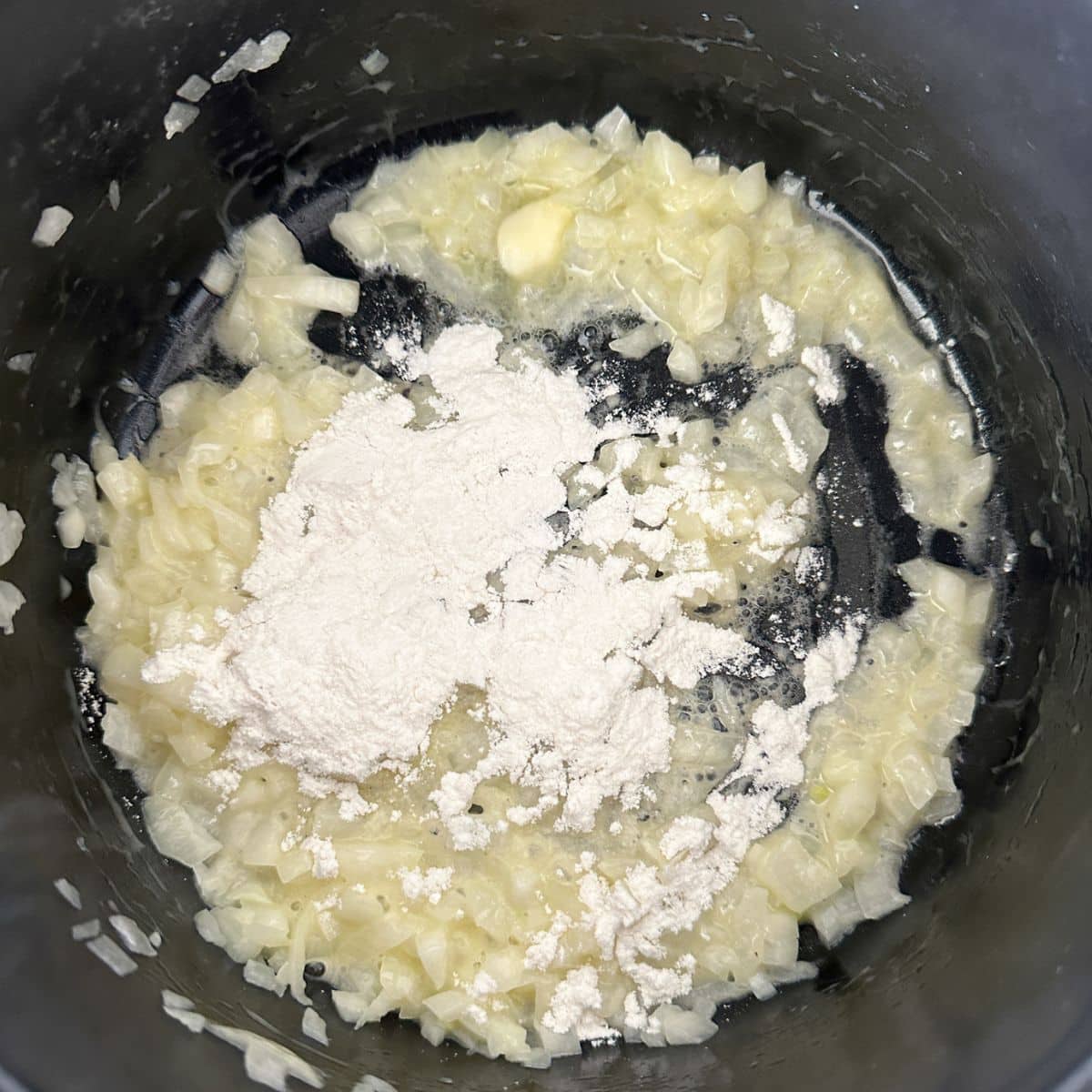 Saucepan with onion, butter, and flour.