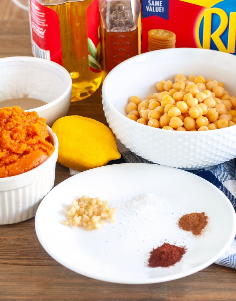 Bowl of pumpkin puree, chickpeas, spices, oil and honey