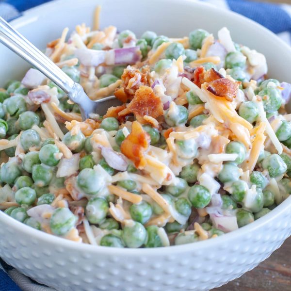 Bowl with peas, cheese and bacon.