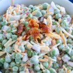 Bowl with peas, cheese and bacon.