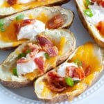 Plate of loaded potato skins make in the air fryer.