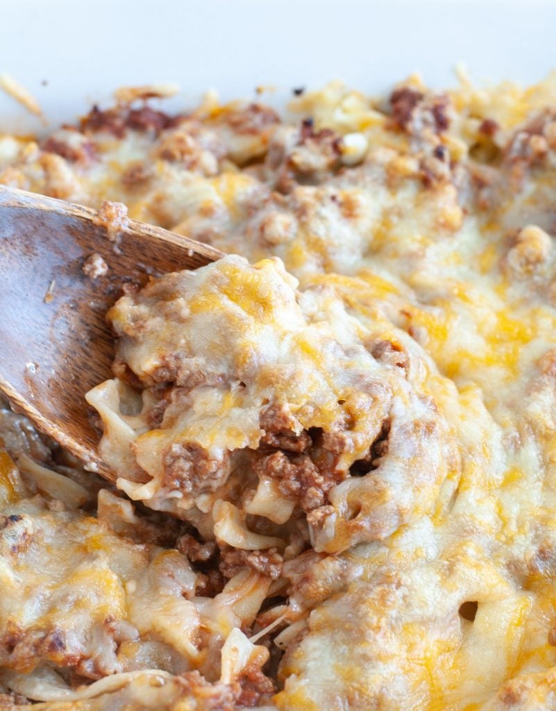 Casserole Dish with Sour Cream noodle bake and a wooden spoon