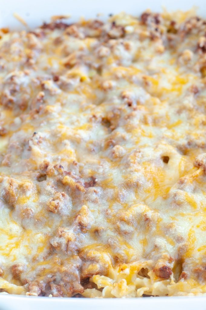 Close shot of sour cream beef noodle bake in a casserole dish.