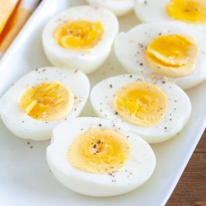 air fryer hard boiled eggs cut in half on a white plate