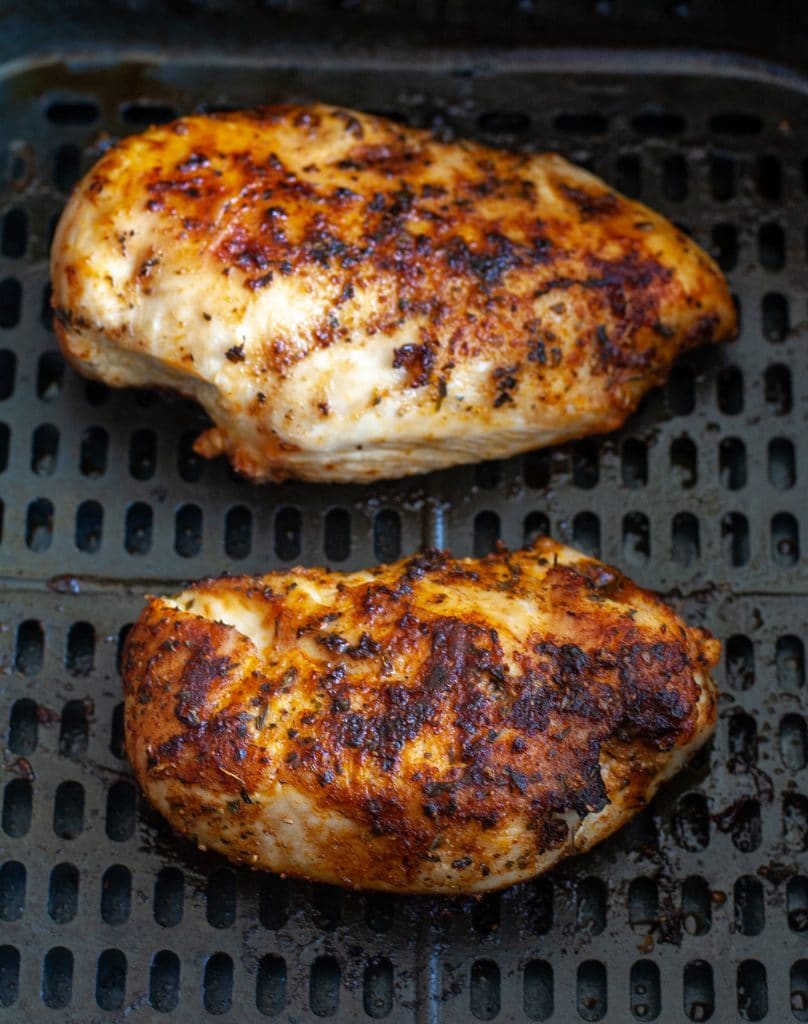 Cooked chicken in air fryer basket