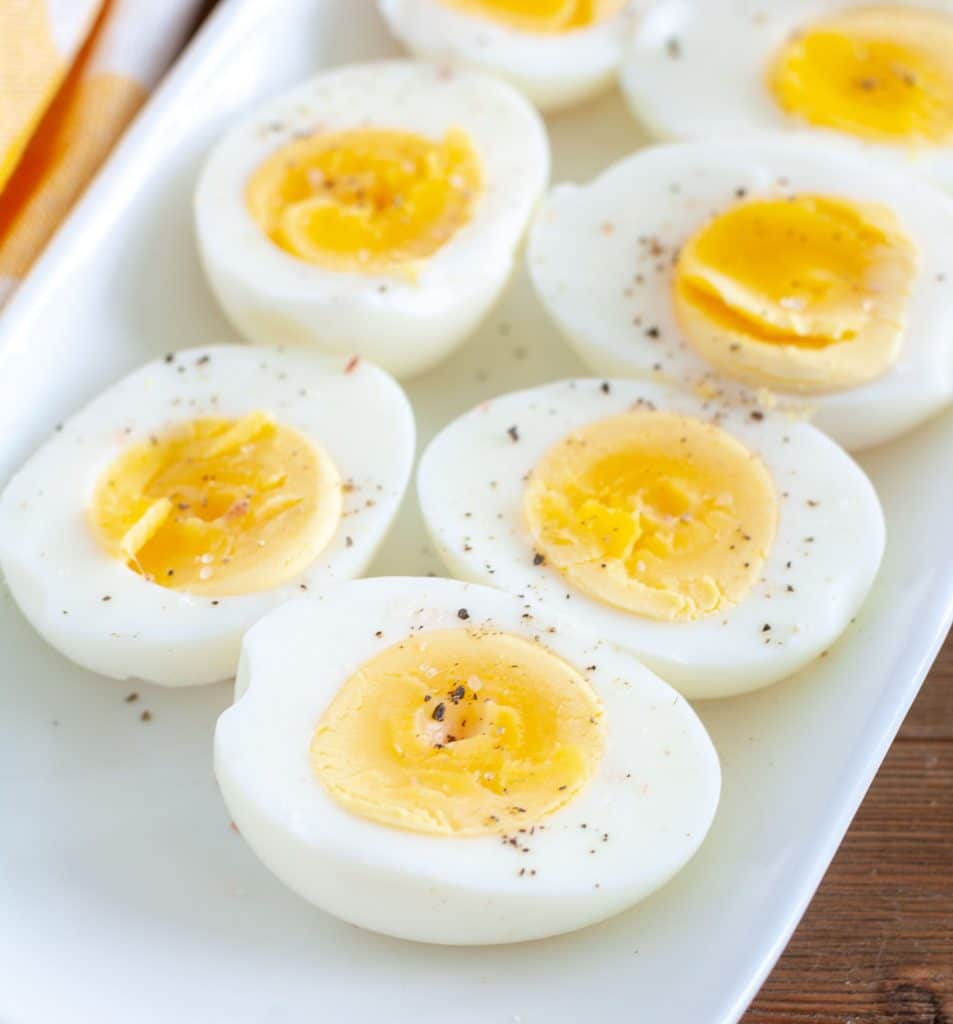 Air Fryer Hard Boiled Eggs cut in half on a white plate