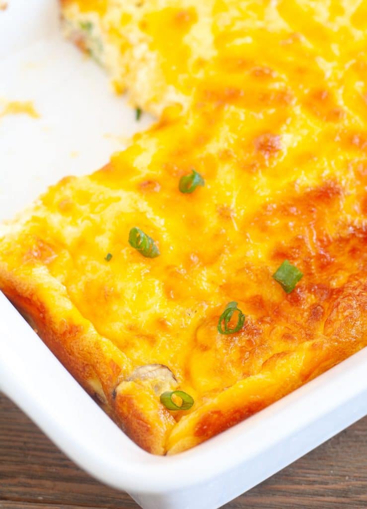Keto breakfast casserole in a baking dish with piece cut out