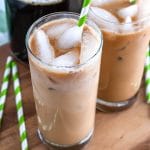 Iced latte in 2 glasses and carafe of coffee