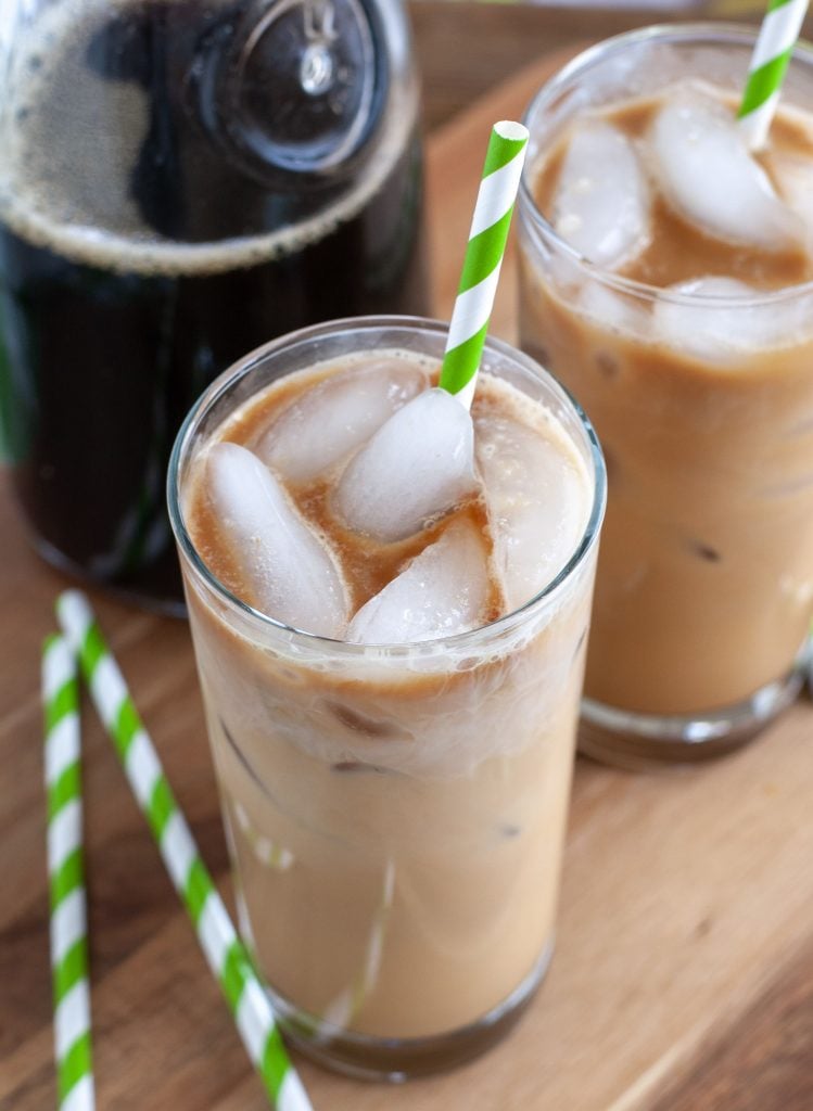 two iced lattes with green and white straw