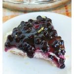 Piece of blueberry pie on plate.