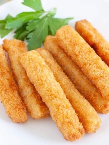 fish sticks on white plate with parsley