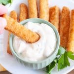 Bowl with tartar sauce and fish sticks