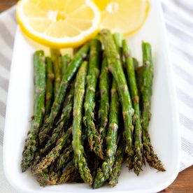 Asparagus on a plate with lemons