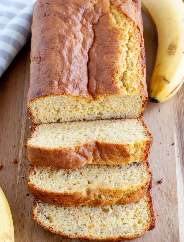 cake mix banana bread on a board with bananas on the side