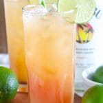 Glass with drink and lime slice.