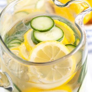 Lemons and cucumber in pitcher of water