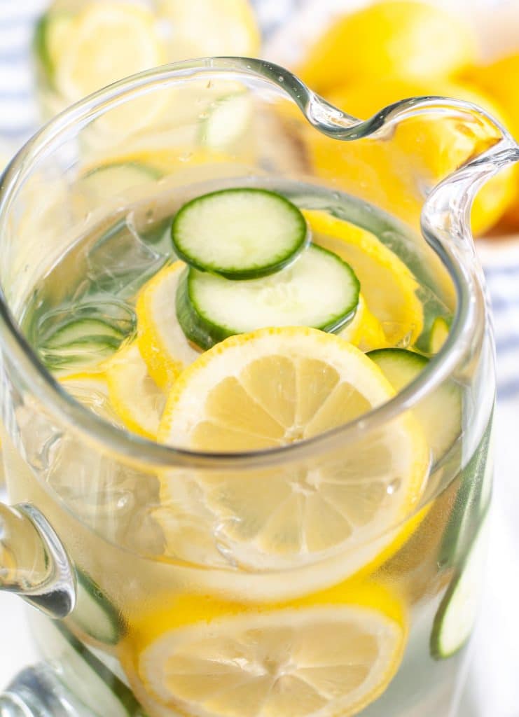 Lemons and cucumber in pitcher of water