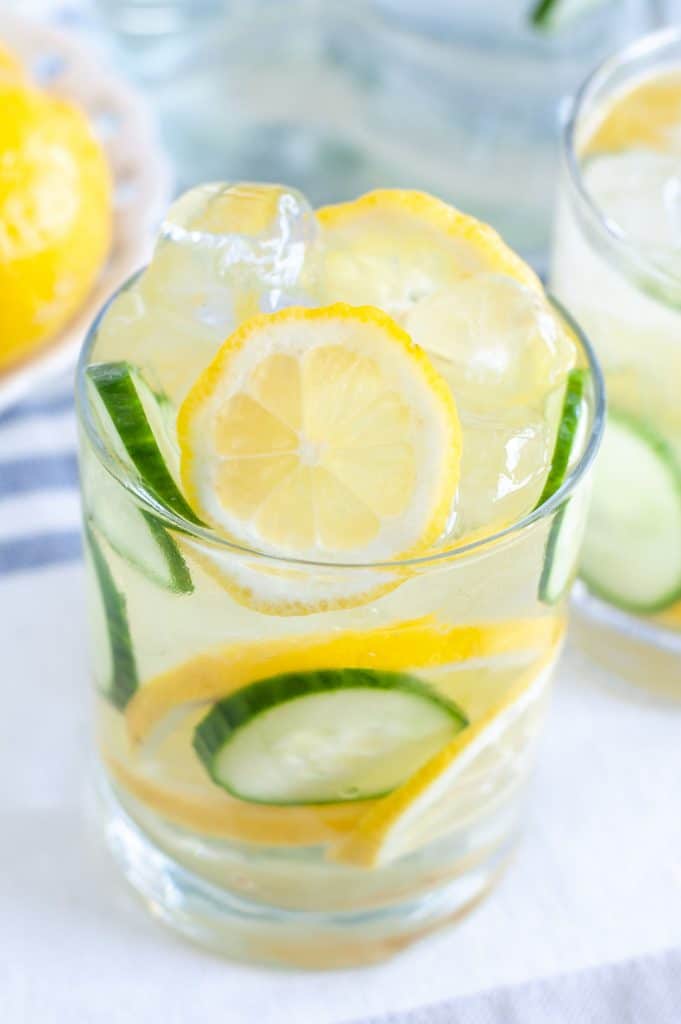 Glass with lemon, cucumber and water
