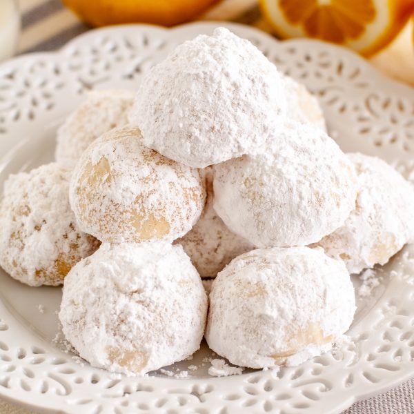 lemon cookies stacked on a plate