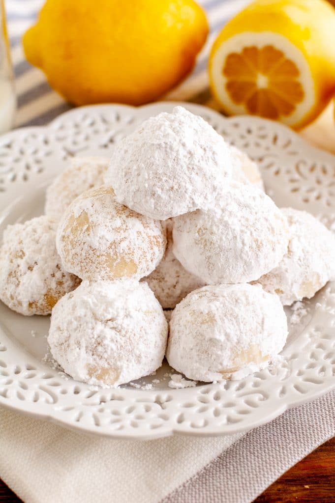 lemon cookies stacked on a plate